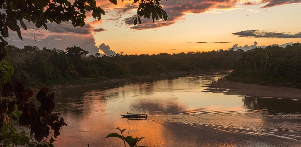 A view of a boat sailing on the Tambopata river