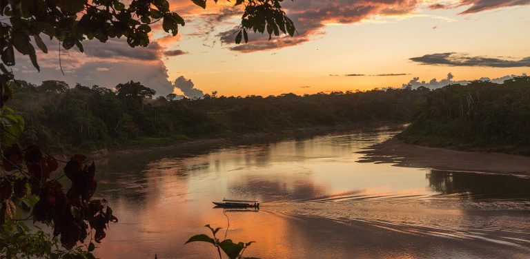 A view of a boat sailing on the Tambopata river